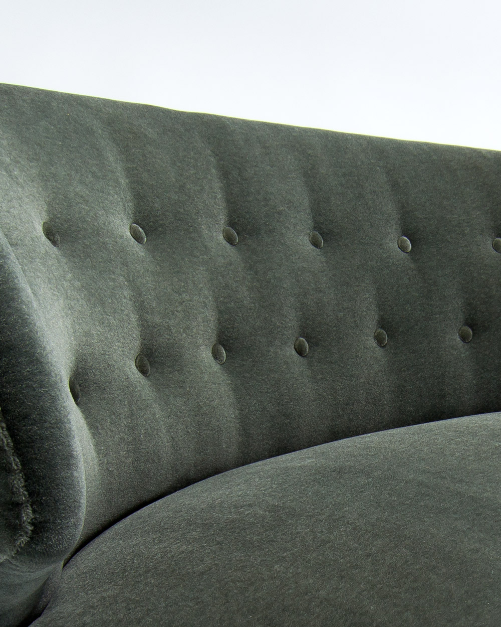 Button back detail of Carl Johan Boman sofa showing tufting and green mohair velvet texture