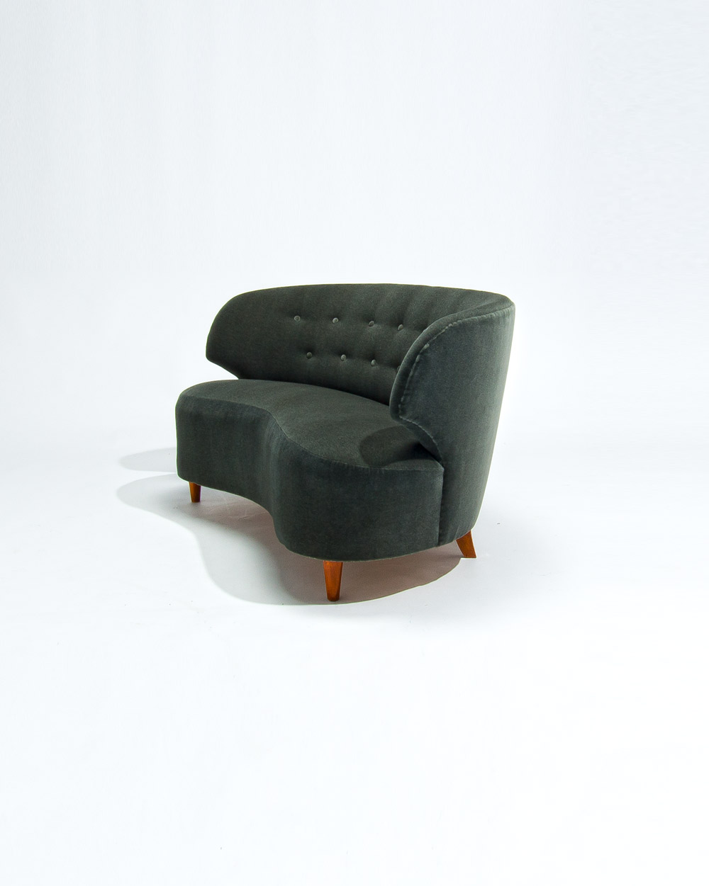 Three quarter view of Carl Johan Boman 1950s sofa in green Dedar mohair velvet