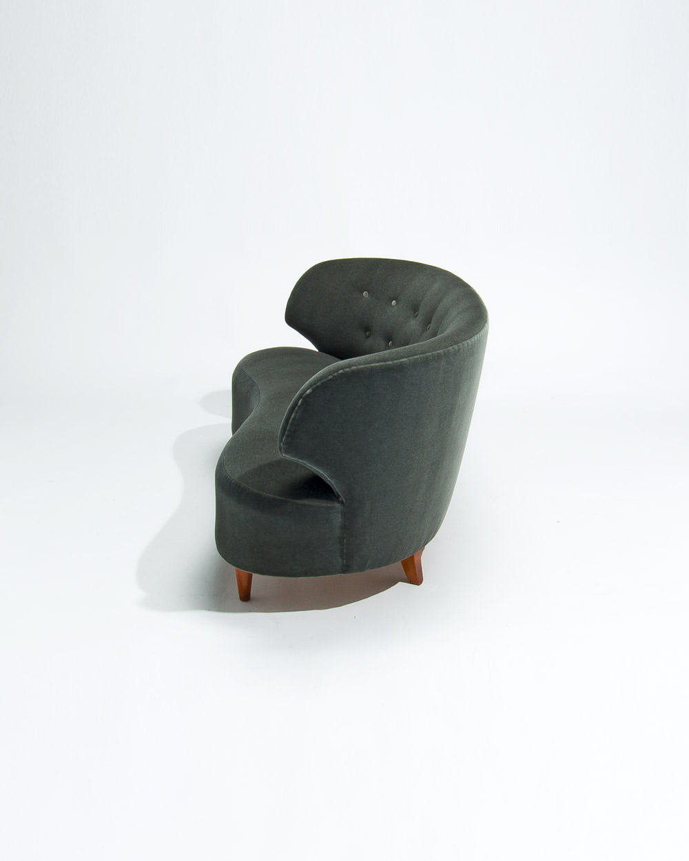 Side profile of Carl Johan Boman sofa showing sculpted curve and green mohair velvet upholstery