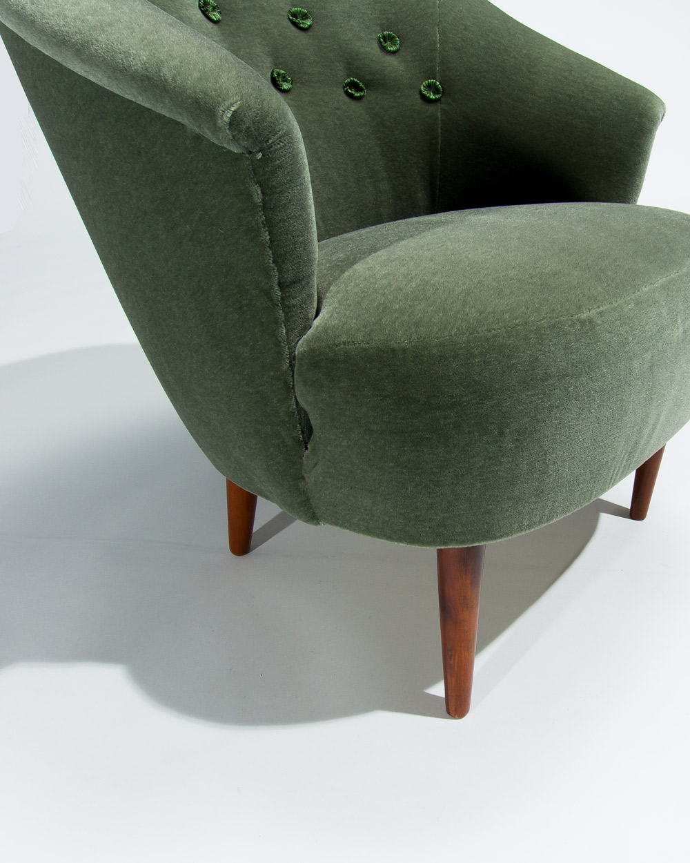 detail of front leg and arm on a Carl Malmsten Swedish lounge chair from the 1950s