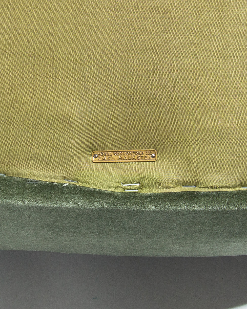 maker's plaque O H Sjögren Tranås Sweden on a Carl Malmsten Swedish lounge chair from the 1950s