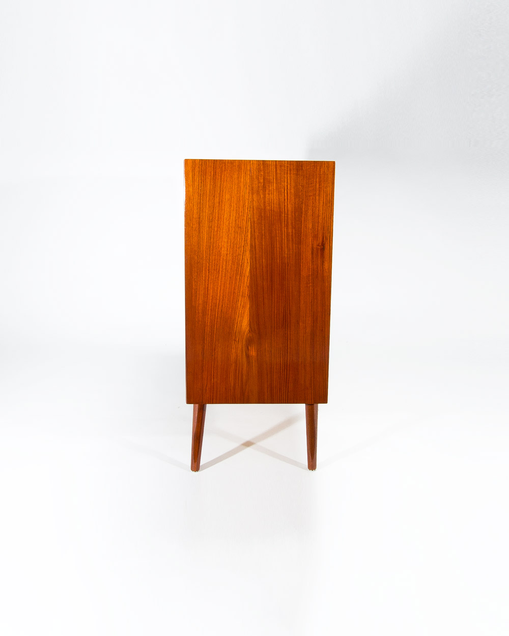Side profile Danish teak chest of drawers 1950s showing teak grain and clean lines