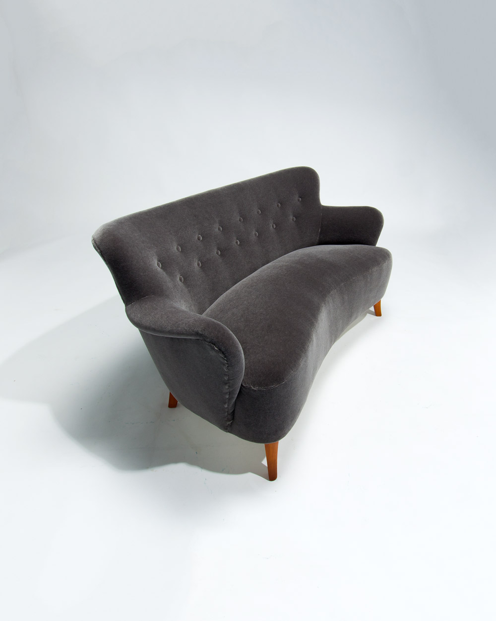 Rear view of Finnish mid century sofa in grey mohair velvet highlighting curved backrest shape