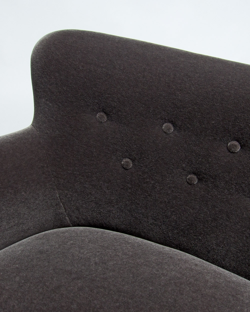 Close up of buttoned back detail in grey Rose Uniacke mohair velvet on Finnish mid century sofa
