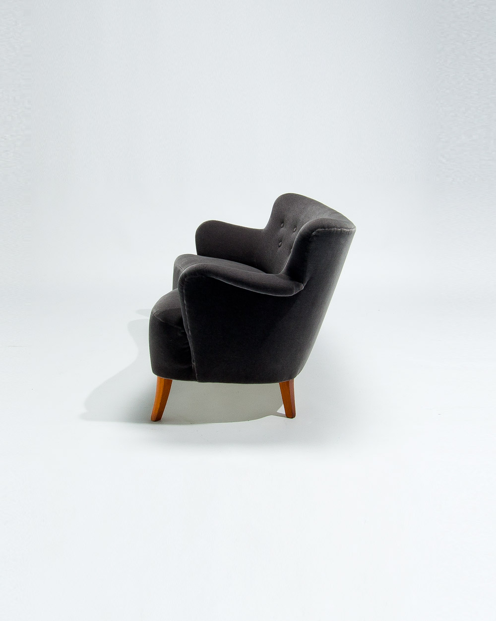 Three quarter view of Finnish mid century sofa in grey mohair velvet with soft organic form