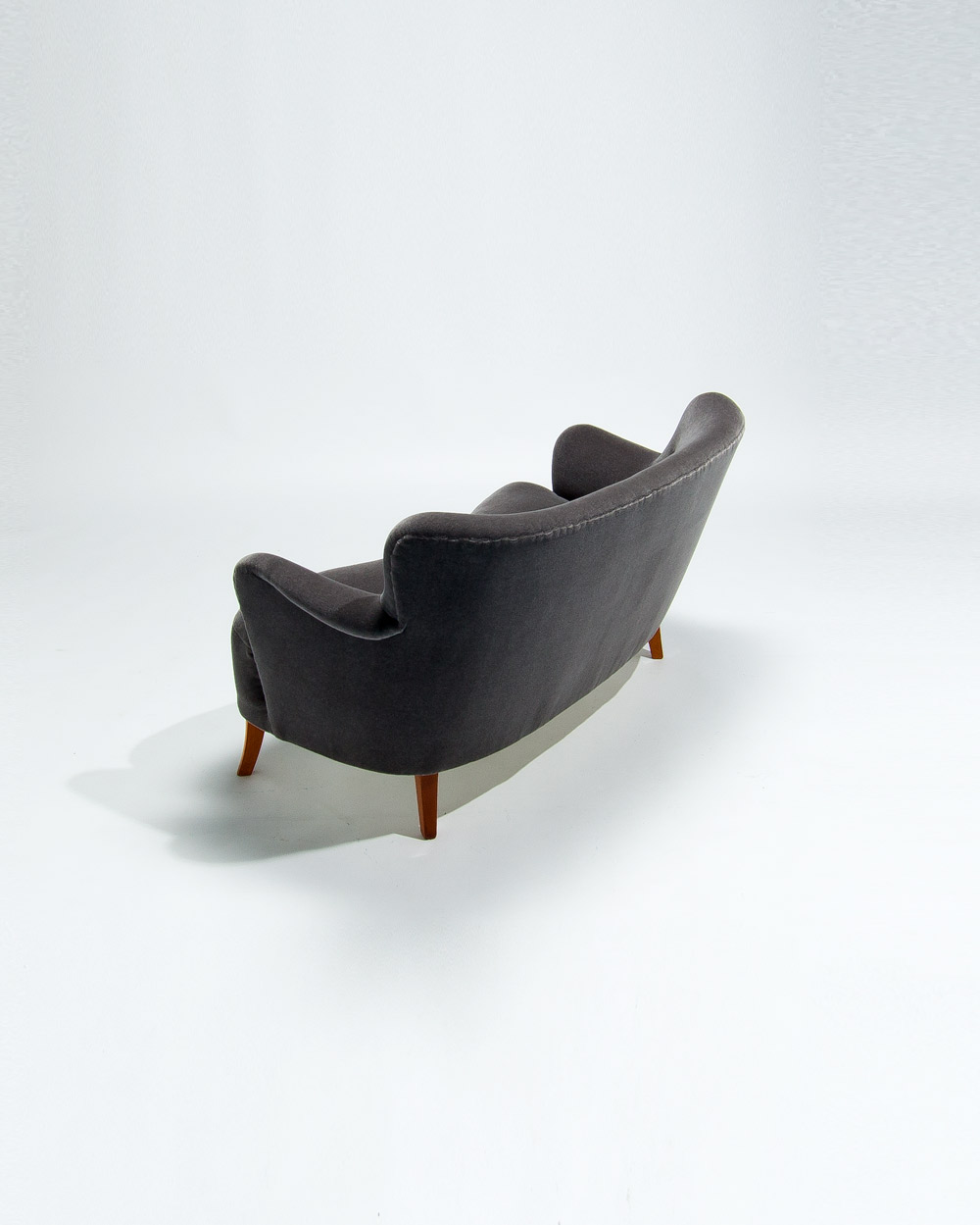 Opposite side view of 1950s Finnish sofa in grey mohair velvet showing gentle curved silhouette