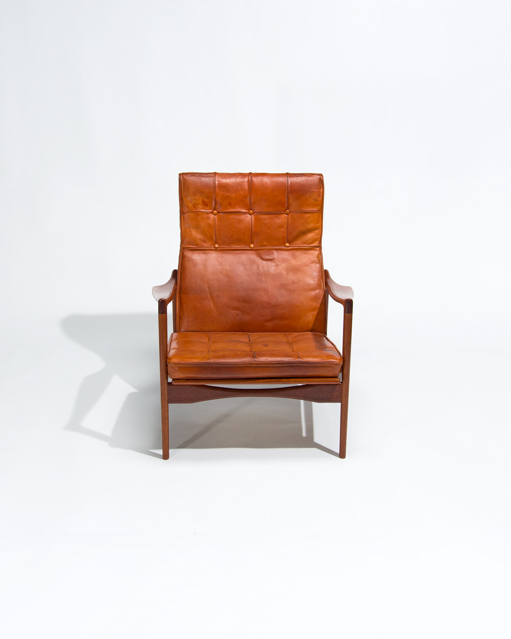 Ib Kofod Larsen lounge chair front view cognac leather and teak frame