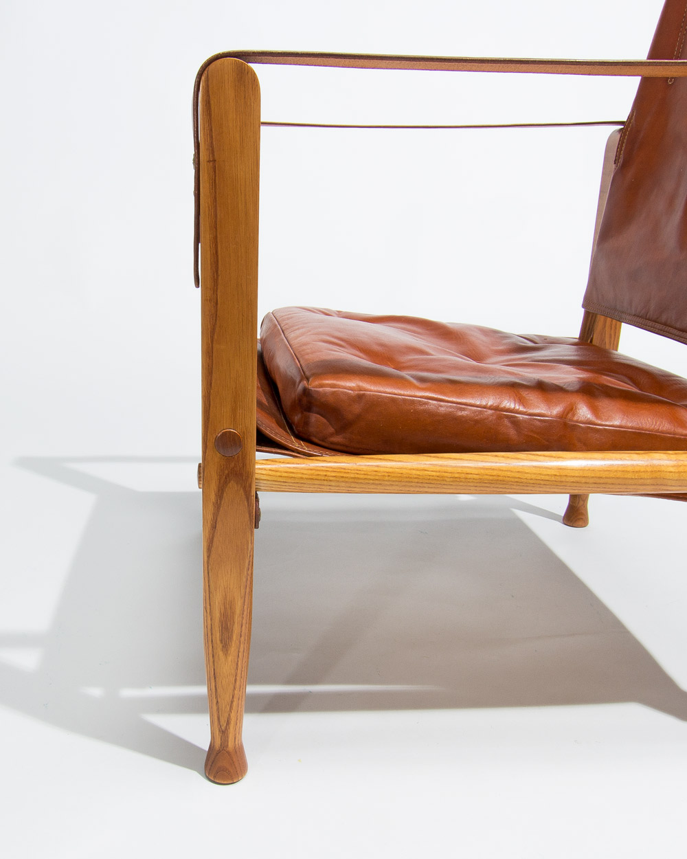 Patinated oak leg detail of Kaare Klint Safari chair Rud Rasmussen