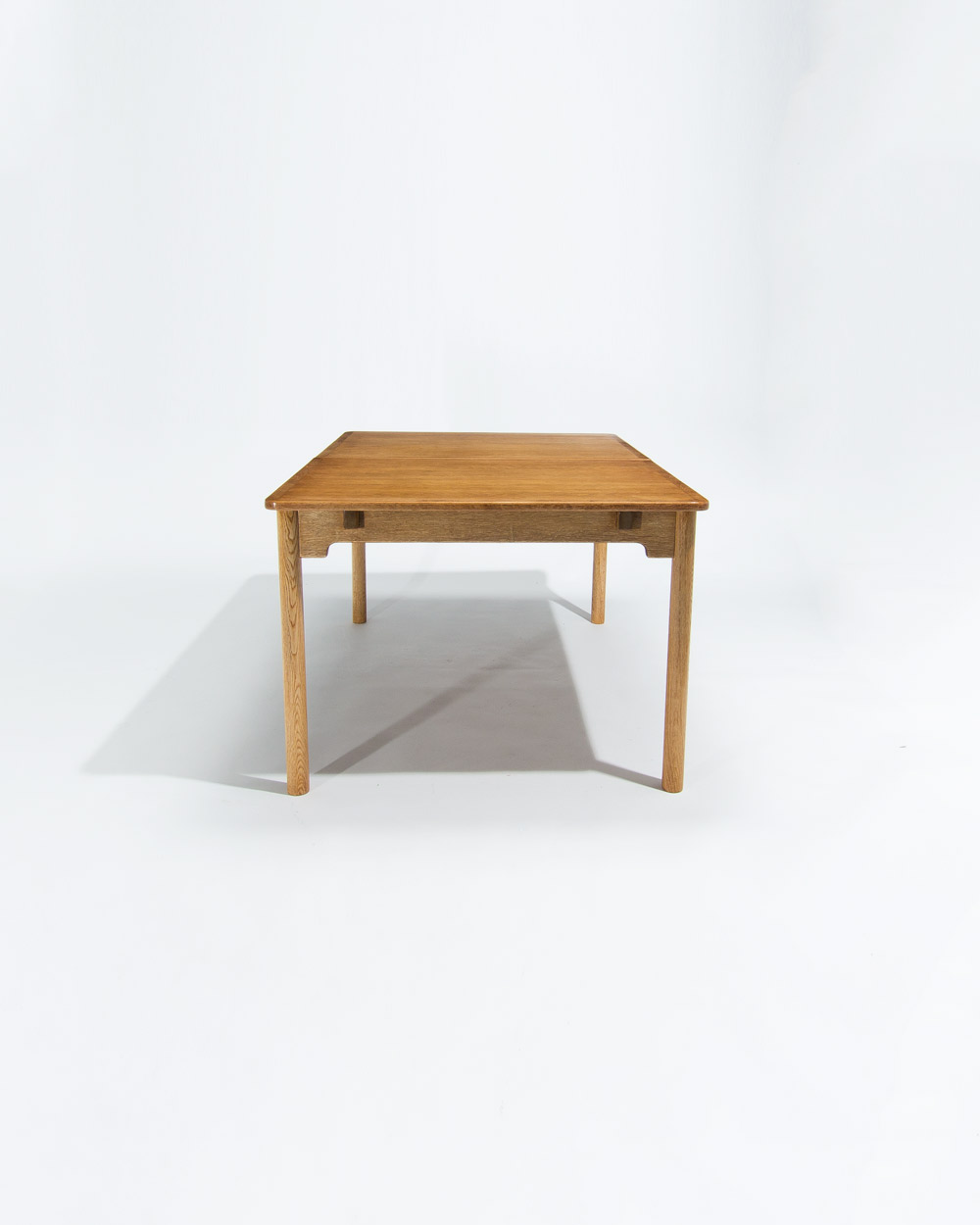 Three quarter view of mid century Swedish oak dining table by Borge Mogensen