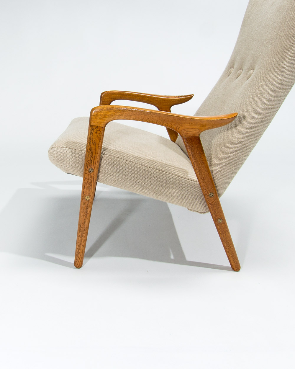 Detail of oak armrest and Pierre Frey linen upholstery on Swedese lounge chair